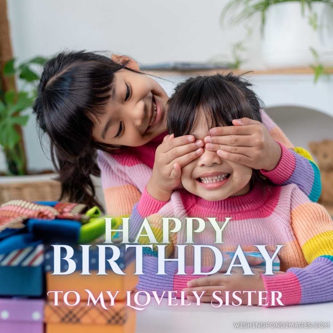 Little girl making present to little happy kid girl holding gift box, closing eyes of cute smiling e